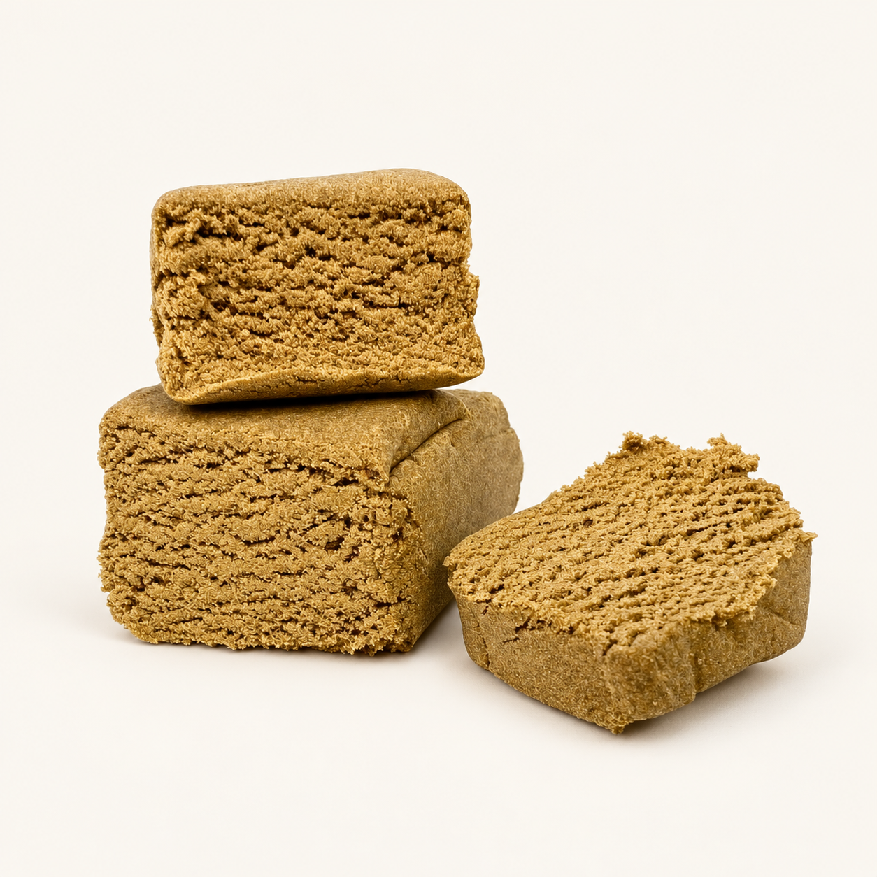 Trois morceaux de résine CBD blonde sur fond crème